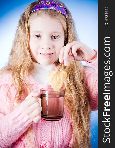 Little girl with tea cup and leaf