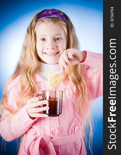 Cute little girl with tea cup and leaf