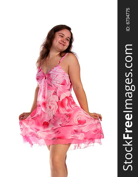 Curly girl in pink dress posing isolated