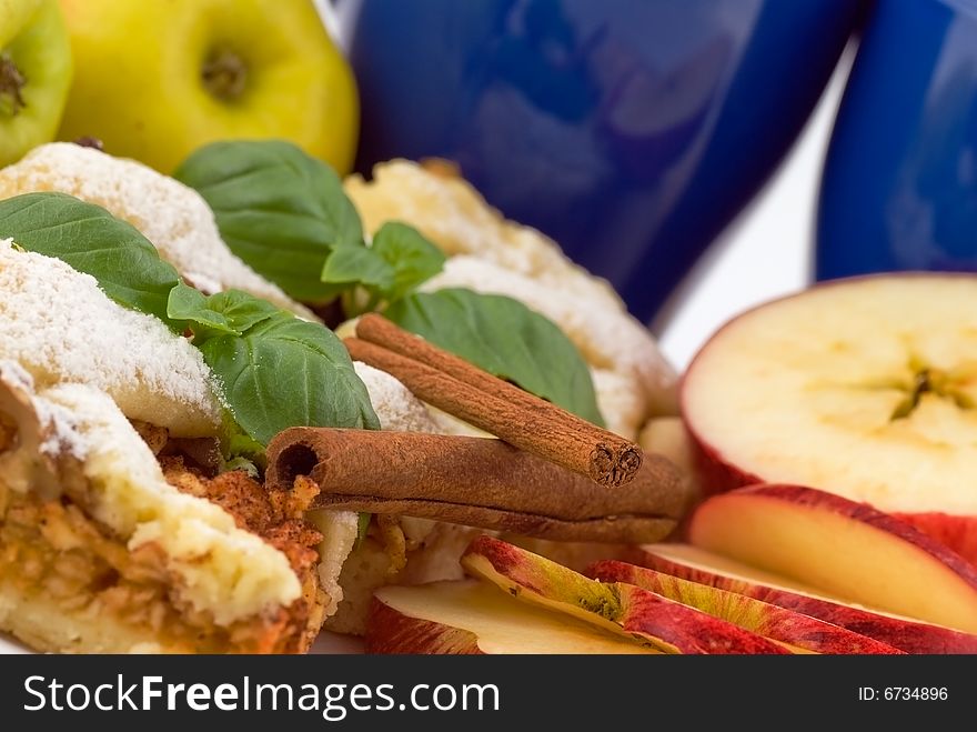 Apple pie on the plate with apples in the background