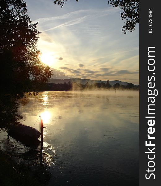 Fog rises over the Rhine River at the German town of Büsingen at dawn. Fog rises over the Rhine River at the German town of Büsingen at dawn.