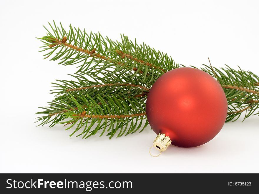 One matte red christmas ball with spruce twig