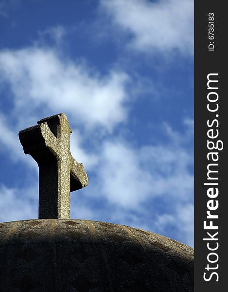 Stone cross low angle view against the sky.