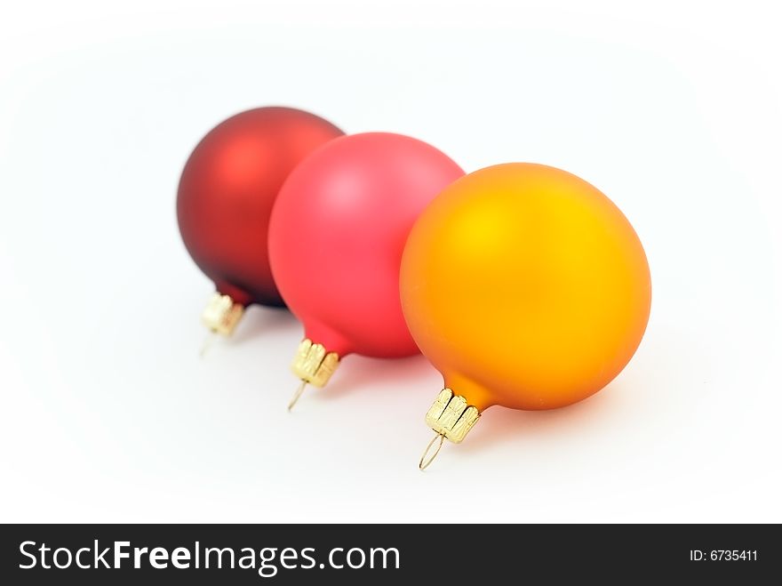 Three colored christmas balls on the white background. Three colored christmas balls on the white background