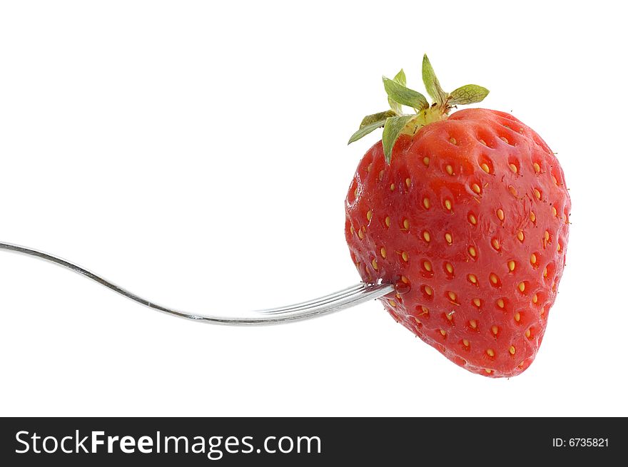 Close-up of a strawberry and fork isolated on a white background. Close-up of a strawberry and fork isolated on a white background