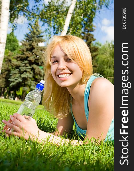 Woman Drinking Water On The Summer Glade