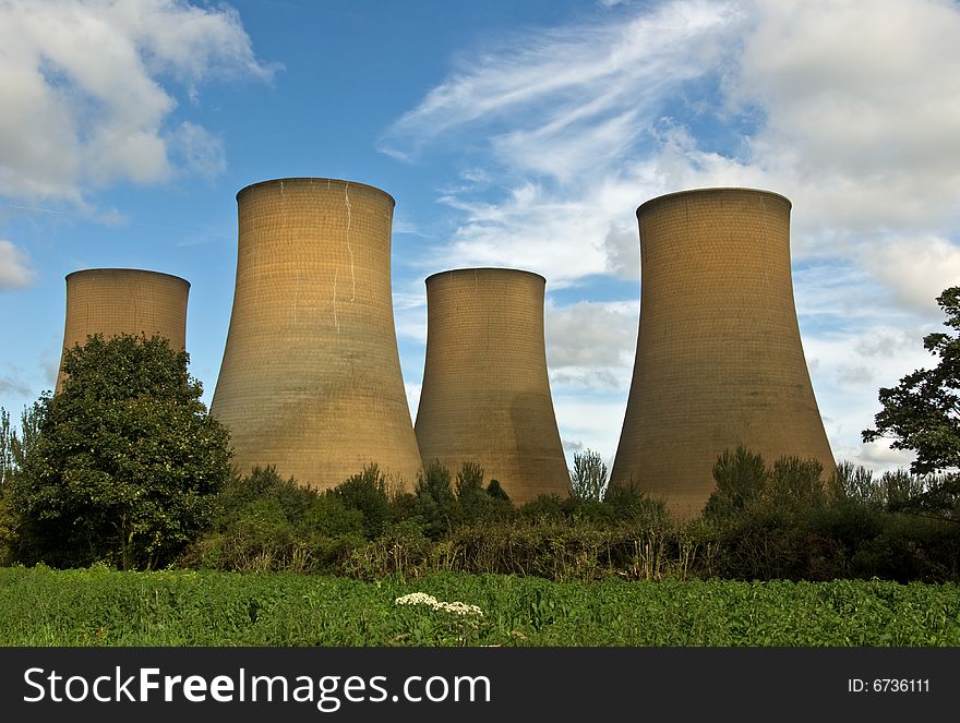 The cooling towers of a power station against a blue sky