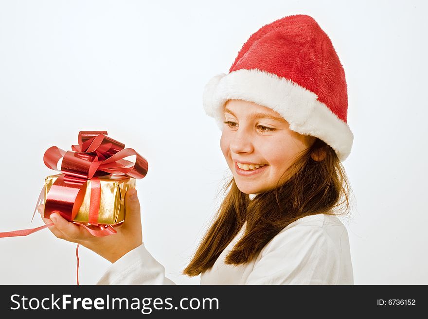 Young girl with hat holding Christmas present. Young girl with hat holding Christmas present