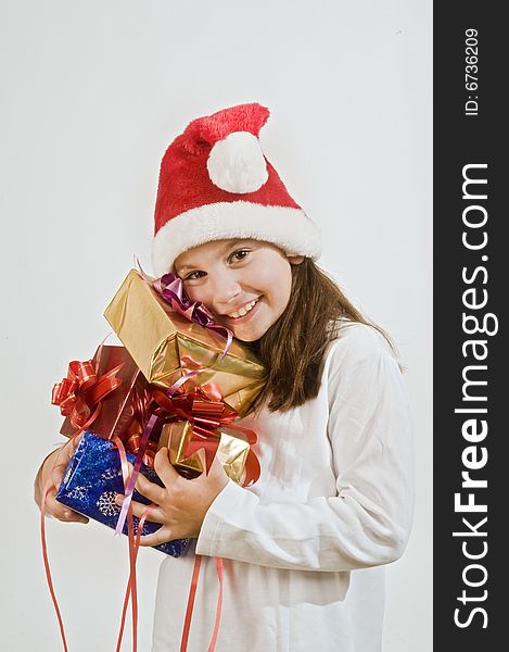 Young girl with hat holding Christmas present. Young girl with hat holding Christmas present