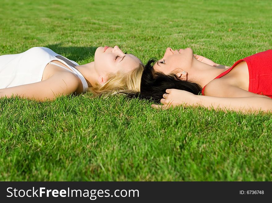 Sweet women rest on the grass