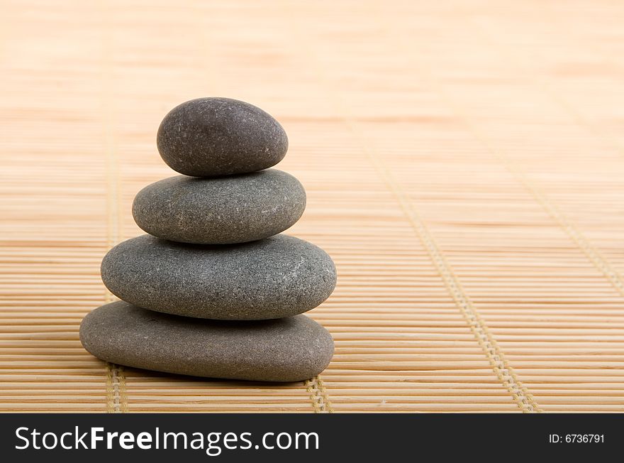 Balanced stones isolated on wooden background