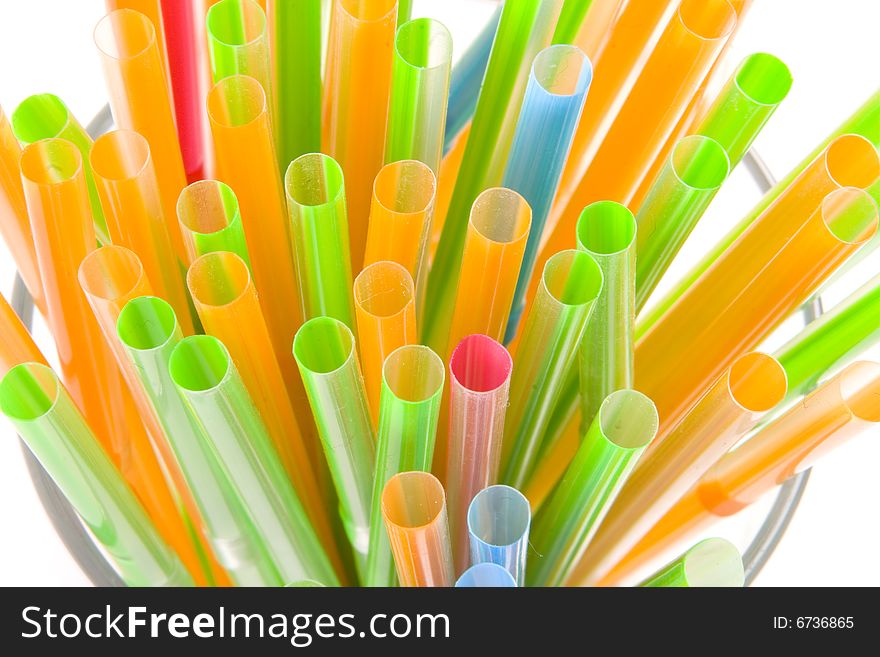 Bunch of multicolored straws on white ground