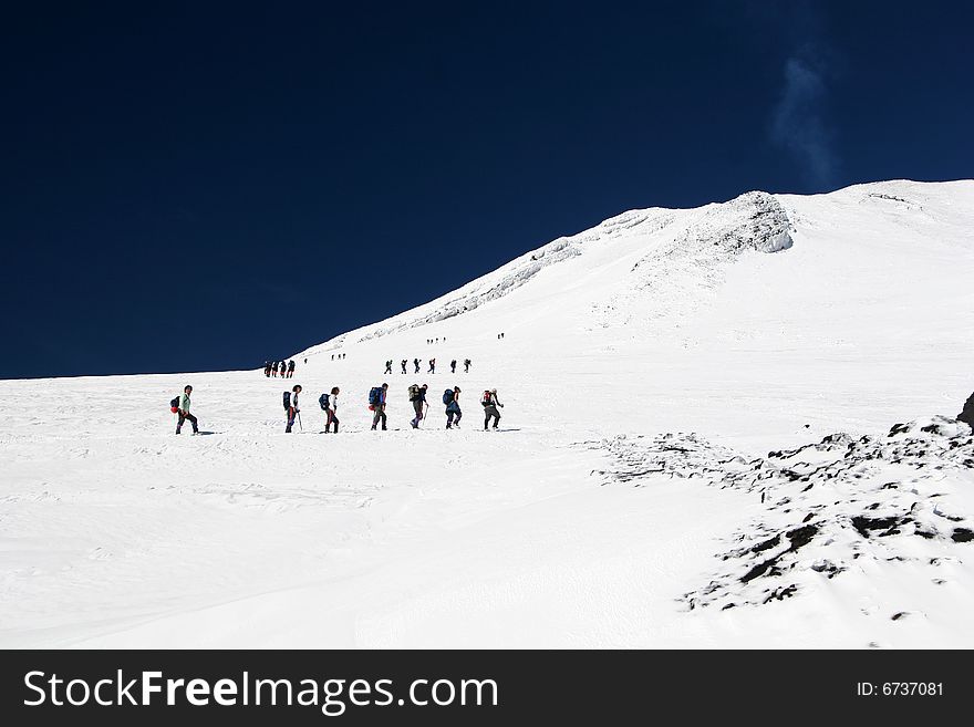 A pair of mountain climber on a snowy mountain. A pair of mountain climber on a snowy mountain