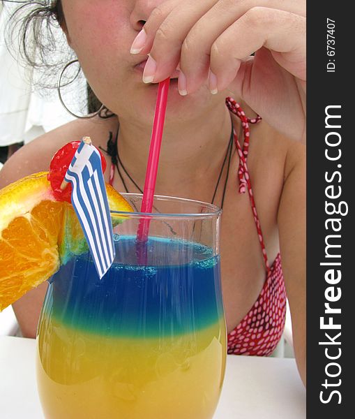 Young lady drinking tropical cocktail