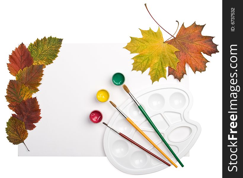 Paints, brushes and autumn leaves