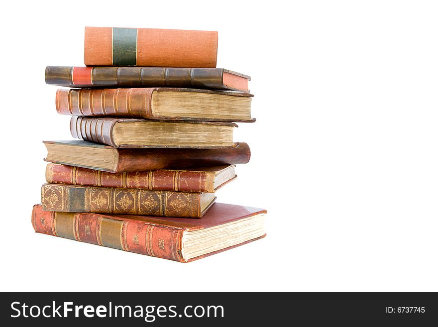 A pile of old leather bound books isolated on a white background