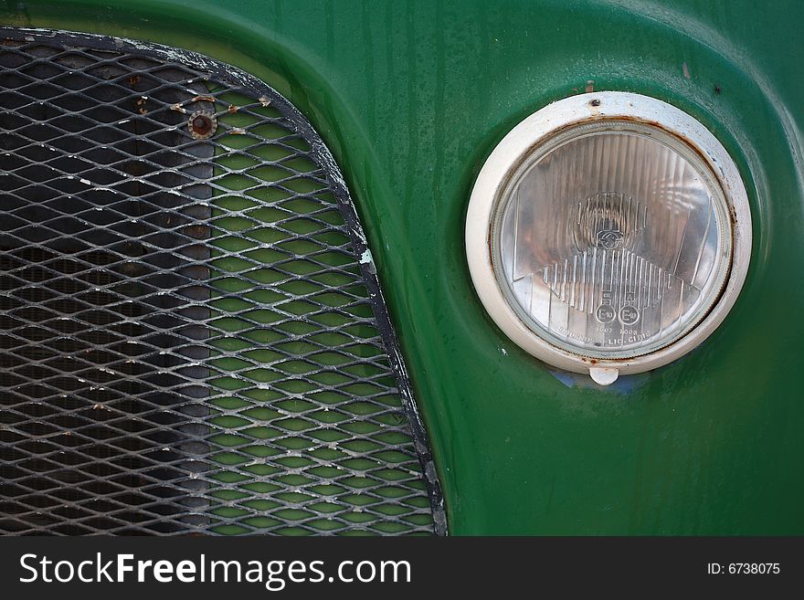 A close up photo of a green vintage car. A close up photo of a green vintage car