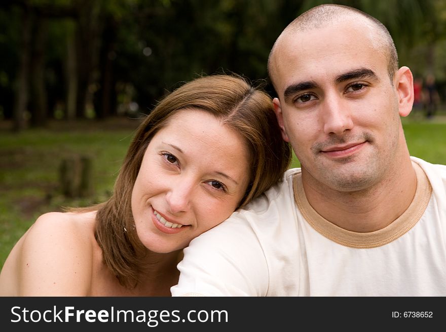 Beautiful young couple on the park in sunny day