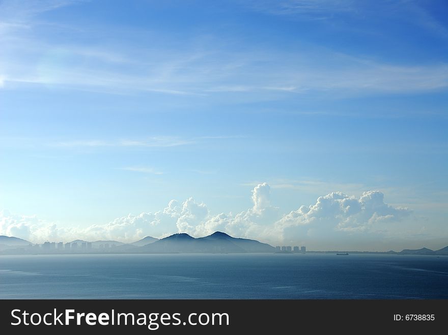 Photo was taken at Sanya bay at morning time, the skyline of Sanya city looks like a mirage. Photo was taken at Sanya bay at morning time, the skyline of Sanya city looks like a mirage