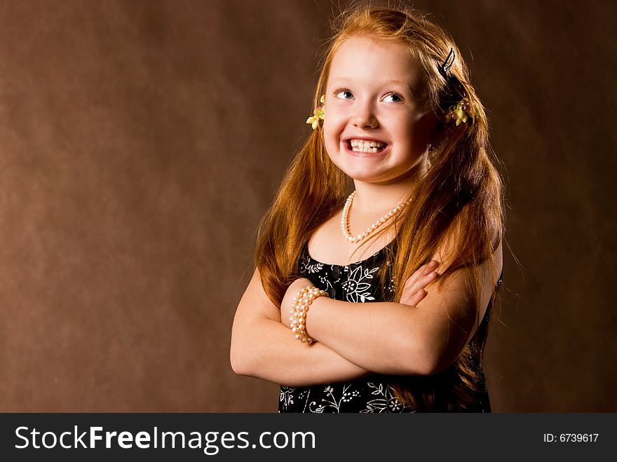 Confident smiling little girl with beautiful ginger hair