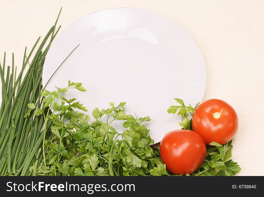 Composition with green vegetables and a plate