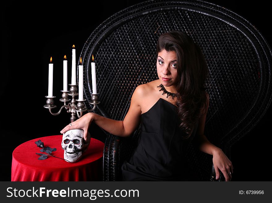 Beautiful Woman in Halloween Setting with skull and candles. Beautiful Woman in Halloween Setting with skull and candles