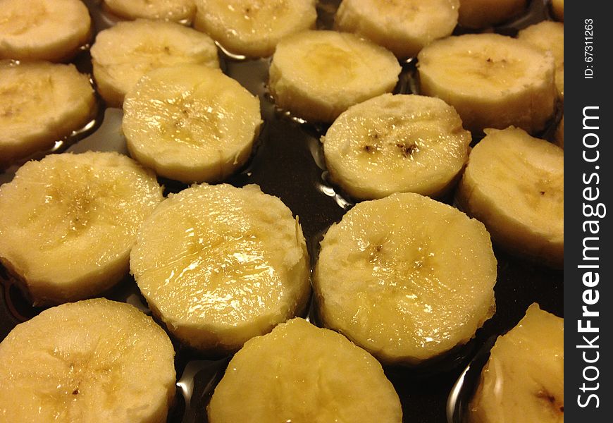 Sliced Bananas on Frying Pan in Oil Ready to be Fried. Sliced Bananas on Frying Pan in Oil Ready to be Fried.