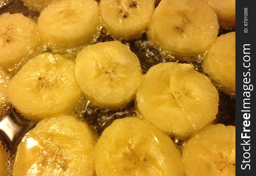 Sliced Bananas Being Fried in Oil on Frying Pan. Sliced Bananas Being Fried in Oil on Frying Pan.