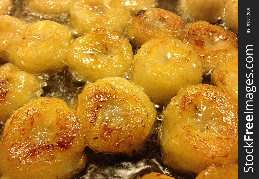 Sliced Bananas Being Fried In Oil.