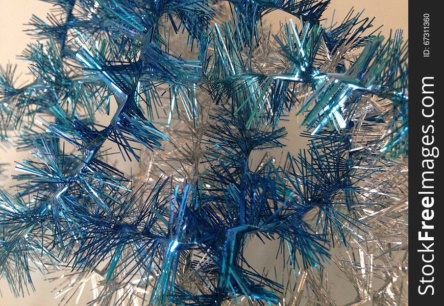 Silver and Blue Christmas Tinsel on White Background. Silver and Blue Christmas Tinsel on White Background.