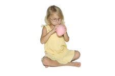 Girl Blowing Up Balloon Royalty Free Stock Photography