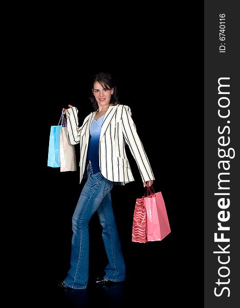 Happy young woman with shopping bags, black background, studio shot. Happy young woman with shopping bags, black background, studio shot