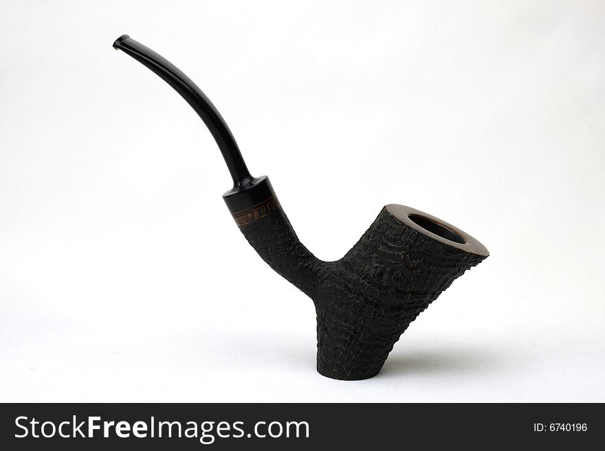 An black tobacco pipe isolated on white background