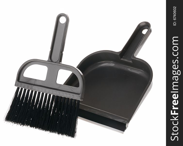 Brush and dustpan. The tool for cleaning it is isolated on a white background