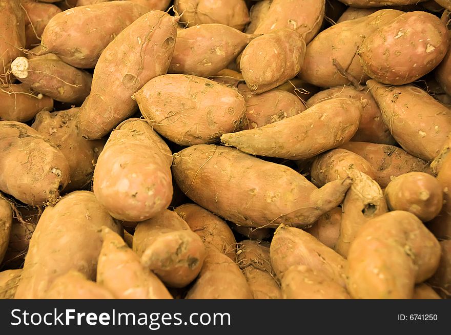 Sweet potatoes displayed at a Farmer's Market.