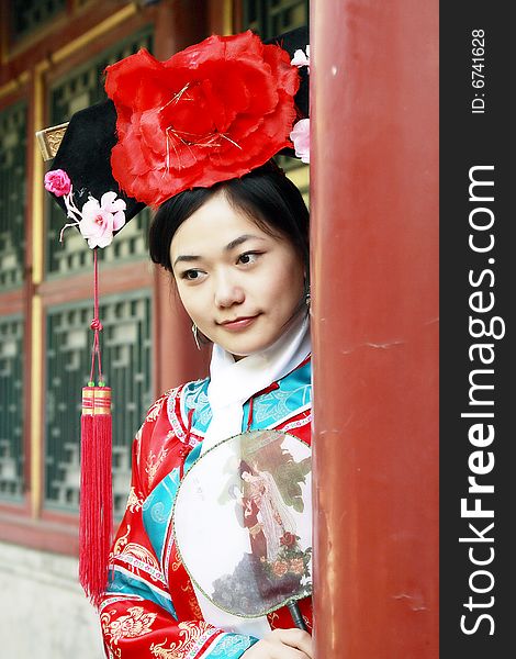 Portrait of a beautiful girl in Chinese ancient dress. 
Chinese on the fan is meant and missed. Portrait of a beautiful girl in Chinese ancient dress. 
Chinese on the fan is meant and missed.