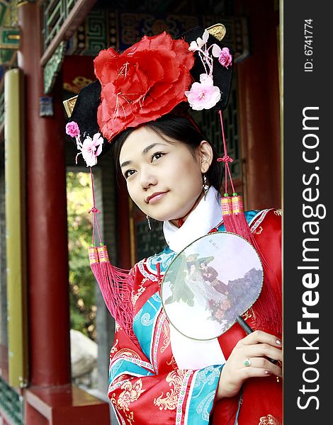 Portrait of a beautiful girl in Chinese ancient dress. 
Chinese on the fan is meant and missed. Portrait of a beautiful girl in Chinese ancient dress. 
Chinese on the fan is meant and missed.