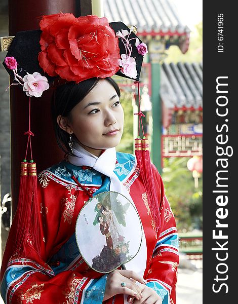 Portrait of a beautiful girl in Chinese ancient dress. 
Chinese on the fan is meant and missed. Portrait of a beautiful girl in Chinese ancient dress. 
Chinese on the fan is meant and missed.