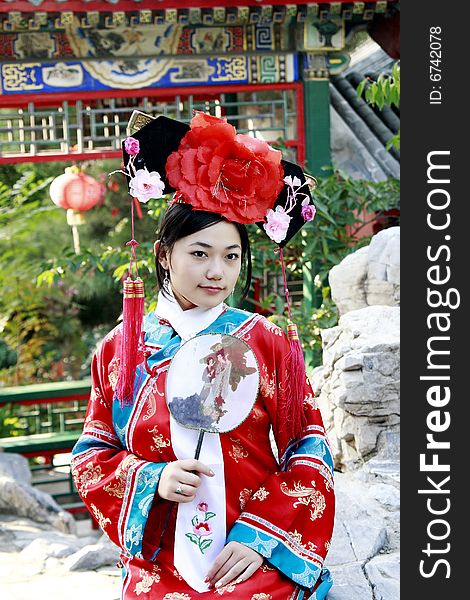 Portrait of a beautiful girl in Chinese ancient dress. 
Chinese on the fan is meant and missed. Portrait of a beautiful girl in Chinese ancient dress. 
Chinese on the fan is meant and missed.