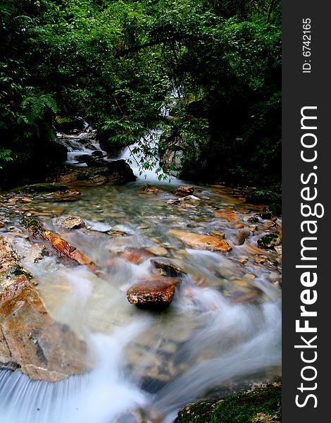 Slow motion capture of a river flowing thru the rainforest. Slow motion capture of a river flowing thru the rainforest