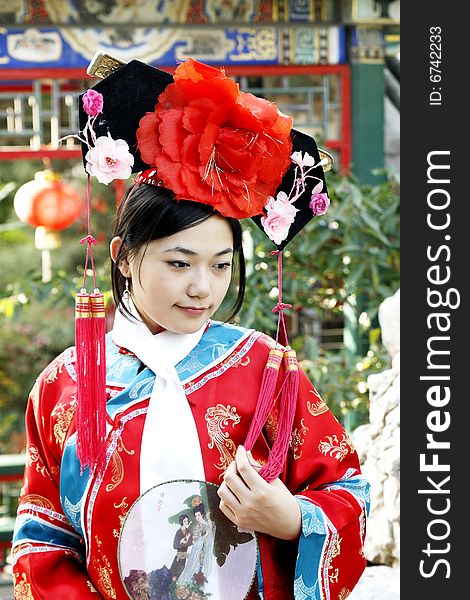 A beautiful girl in Chinese ancient dress is in the royal garden.

This is dress of Qing Dynasty of China. It is the princess' dress too.

Chinese on the fan is meant and missed. A beautiful girl in Chinese ancient dress is in the royal garden.

This is dress of Qing Dynasty of China. It is the princess' dress too.

Chinese on the fan is meant and missed.