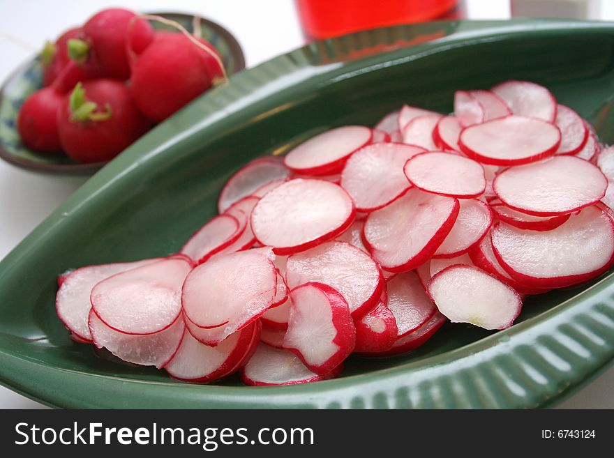 A salad of fresh red radish in decorative table-ware
