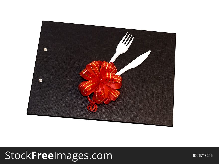 Plastic spoon and fork on a black file with red bow.
