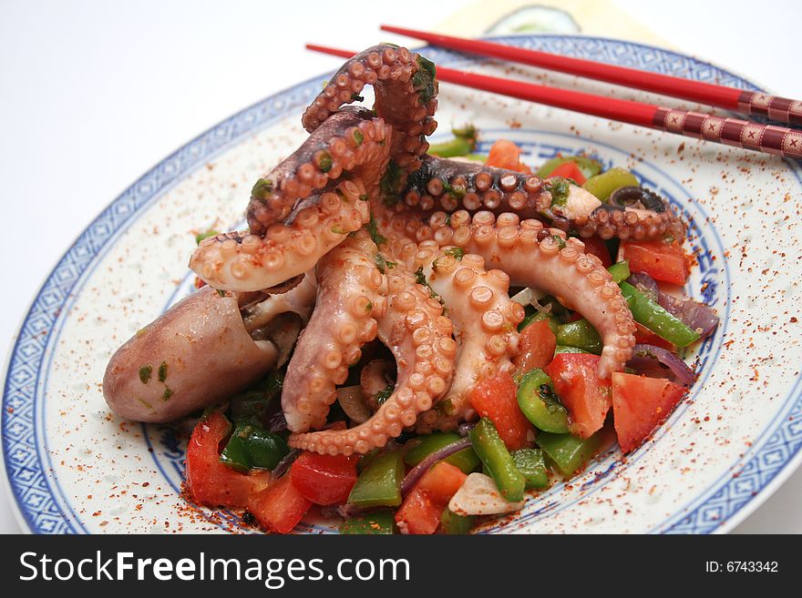 A salat of octopus with some vegetables