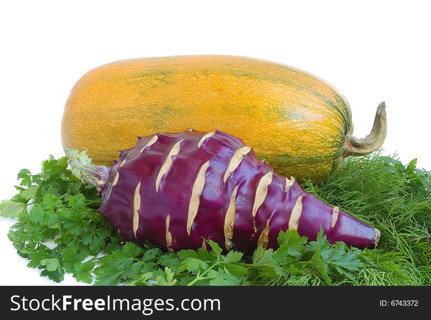 Yellow summer squash, kohlrabi and greens on white background