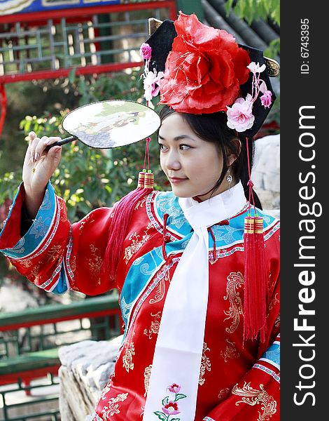 Portrait of a beautiful girl in Chinese ancient dress. 
Chinese on the fan is meant and missed. Portrait of a beautiful girl in Chinese ancient dress. 
Chinese on the fan is meant and missed.