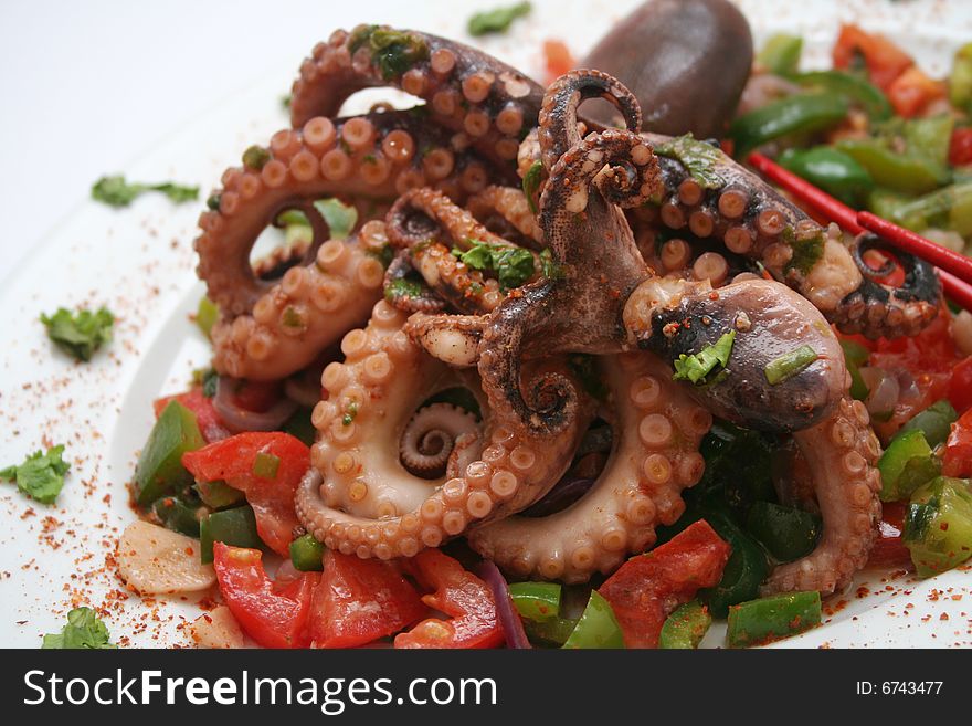 A grilled octopus with different kind of vegetables