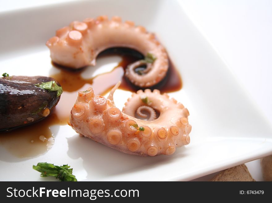 A meal of a fresh octopus with some sauce