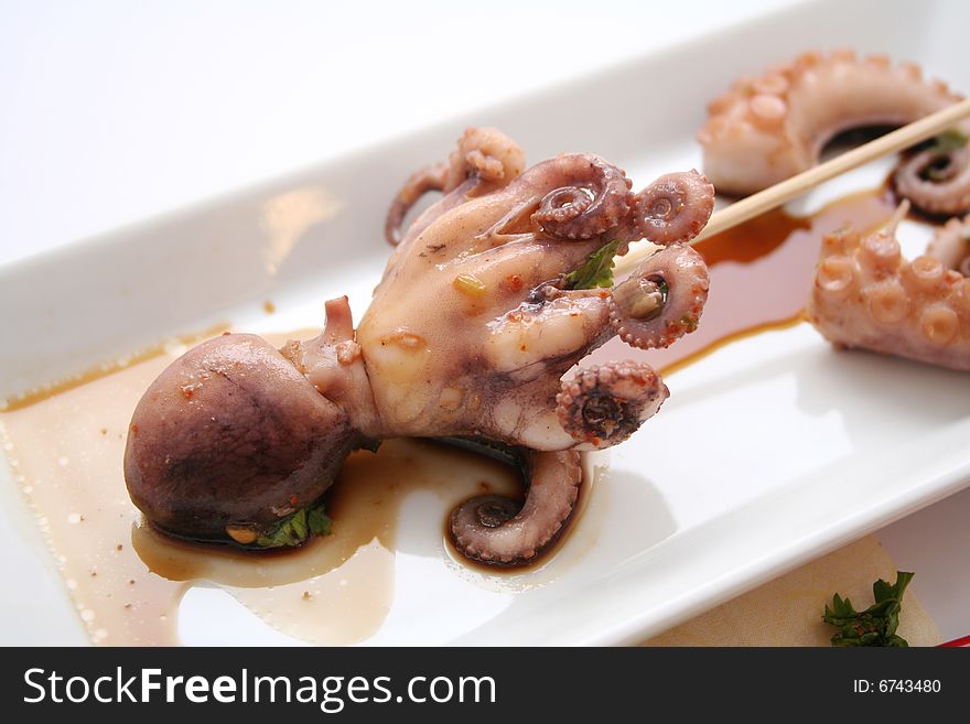 A meal of a fresh octopus with some sauce