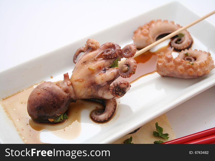 A meal of a fresh octopus with some sauce